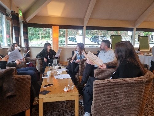 Graduates working together in a breakout area